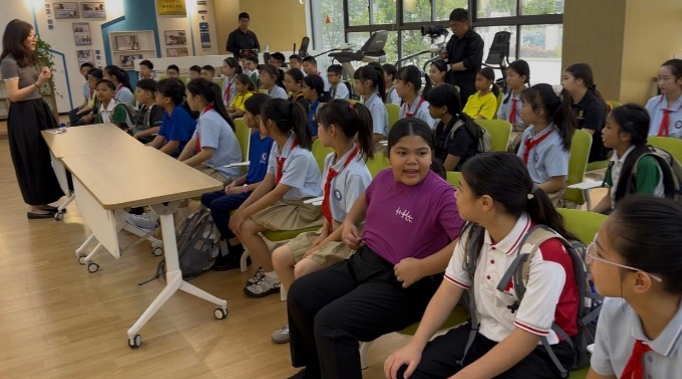 Students attending an educational talk during an overseas learning visit.